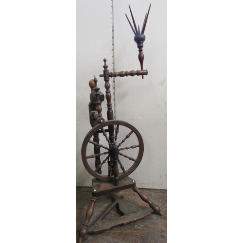 2803 - An early 19th century upright spinning wheel, the turned spindles in fruitwood and other timbers