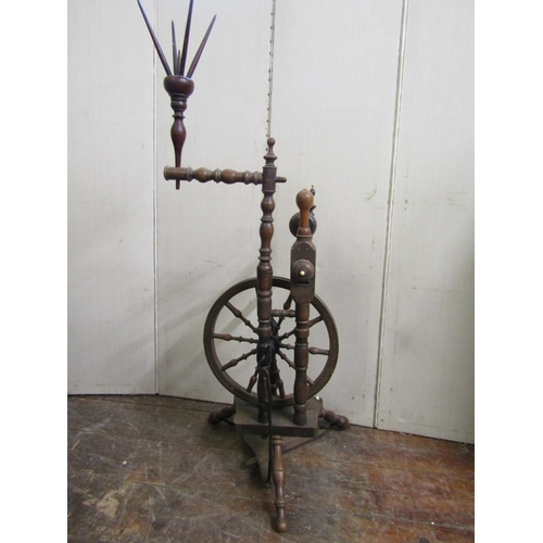 2803 - An early 19th century upright spinning wheel, the turned spindles in fruitwood and other timbers