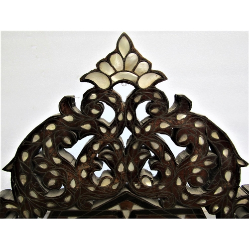 2822 - A late 19th century Moorish wall mirror with honeycomb pierced detail and repeating foliate decorati... 