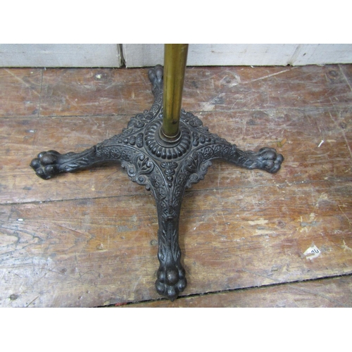 2829 - A Victorian reading stand with cast iron base, lions paw feet, the brass column supporting a circula... 