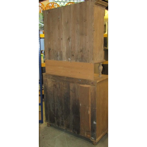 2241 - A stripped pine two sectional kitchen dresser, enclosed by four doors (the upper glazed) and three d... 