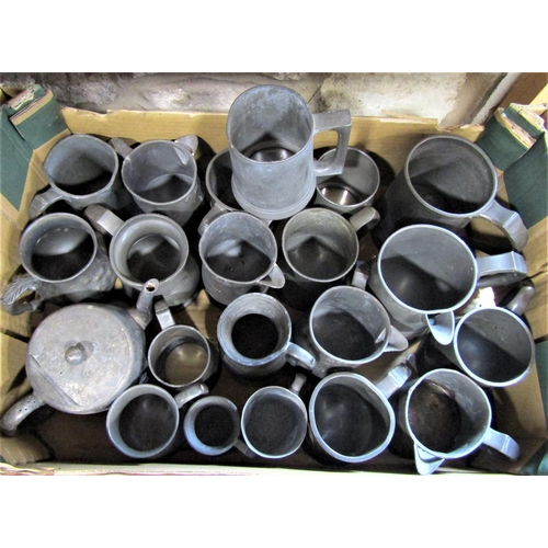 705 - A box containing a large collection of pewter tankards