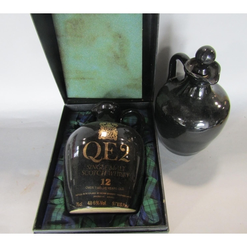 709 - A case QEII single scotch whiskey ewer, together with a further QEII whiskey ewer, a collection of p... 