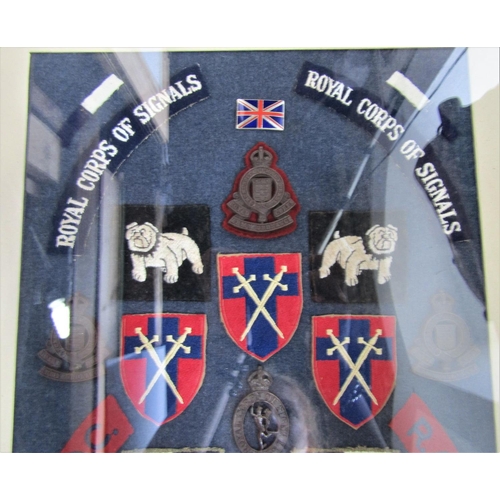 717 - 20th century framed fire screen fitted with a collection of military badge and patches, glazed, 74cm... 