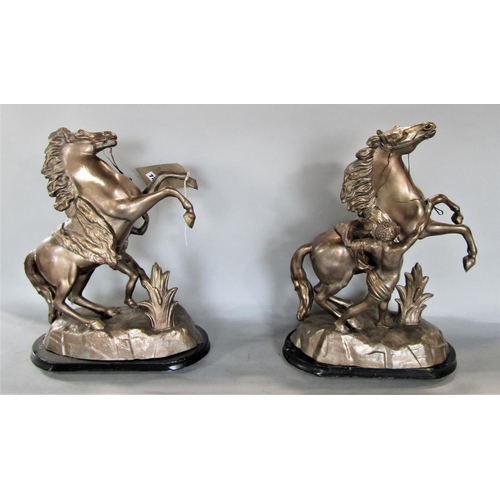 725 - a pair of cast spelter figures of Marley horses, upon oval ebonised plinth bases, 44cm high (2)