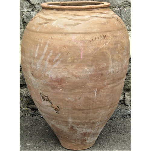 2160 - Two similar buff coloured terracotta oviform tapered jars with incised reeded banded detail, 66cm hi... 