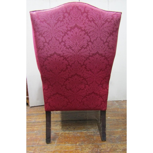 2783 - A Georgian wing chair with scrolled arms, raised on square cut supports