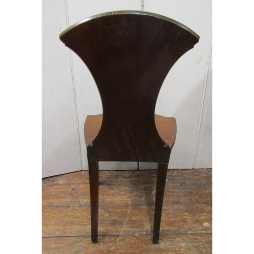 2788 - A Georgian mahogany hall chair with solid seat, the shaped back with armorial crest of an eagle with... 