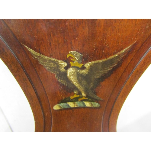 2788 - A Georgian mahogany hall chair with solid seat, the shaped back with armorial crest of an eagle with... 