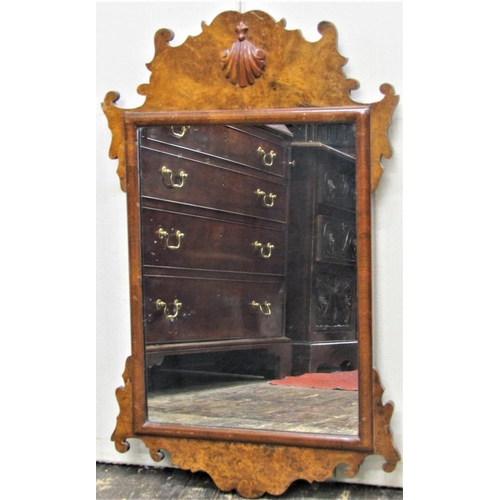 2836 - A small Georgian style wall mirror, with fretted outline and burr walnut veneers with applied shell ... 