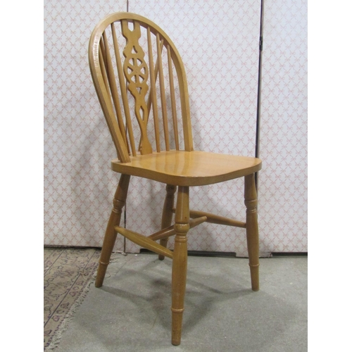 2256 - A set of eight modern beechwood Windsor hoop and stick back dining chairs with central pierced wheel... 