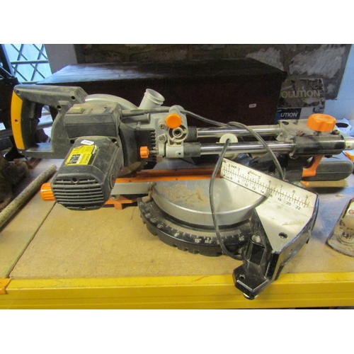 2266 - An Evolution electric multi purpose sliding mitre saw together with a box of miscellaneous tools, in... 