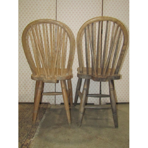 2268 - A Harlequin set of six stripped elm and beechwood hoop and stick back kitchen chairs raised on ring ... 