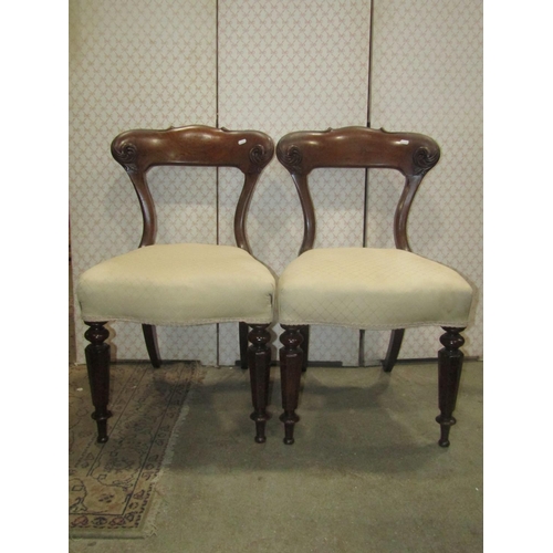 2269 - A pair of Victorian mahogany dining chairs with upholstered seats, carved and moulded frames raised ... 