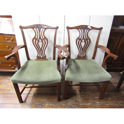 2780 - A set of four Georgian style elbow chairs with carved and pierced splats, stuff over seats and squar... 