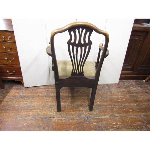 2781 - A Georgian mahogany elbow chair with carved and priced splat and upholstered seat on square cut supp... 