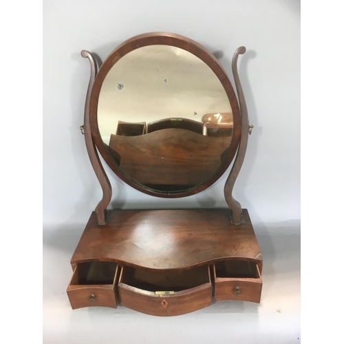 703 - 19th century mahogany toilet mirror, with oval plate upon a serpentine base, fitted with three drawe... 