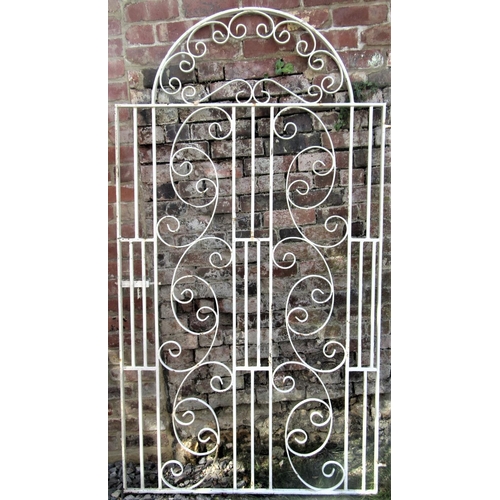 2092 - A reclaimed cream painted ironwork pedestrian side gate of stepped or shouldered arched form, with d... 