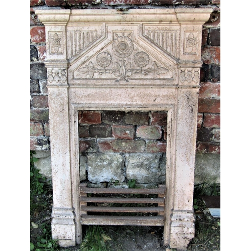 2093 - A late Victorian cast iron bedroom grate with raised relief foliate and fluted detail, painted finis... 