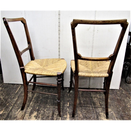 2799 - A pair of Victorian walnut side chairs with rush seats on swept supports and rails