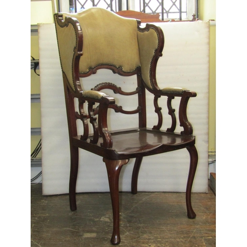 2814 - A James Shoolbred & Co mahogany wing chair, stamped V3343, with saddle seat, shaped ladderback and s... 