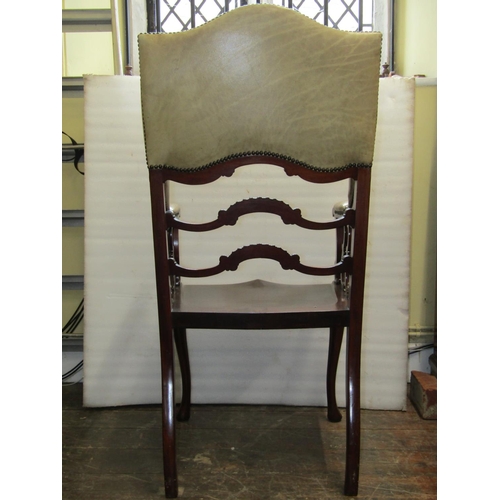 2814 - A James Shoolbred & Co mahogany wing chair, stamped V3343, with saddle seat, shaped ladderback and s... 