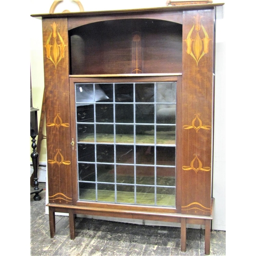 2819 - An art nouveau side cabinet with geometric marquetry panels to a central leaded light door on square... 