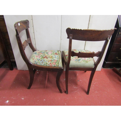 2831 - A pair of Regency flamed mahogany sabre legged side chairs with carved detail and hand worked tapest... 