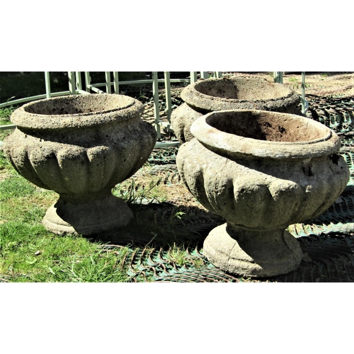 2081 - A set of three reclaimed garden urns, with circular lobed form, approx 40cm diameter x 33cm high (af... 