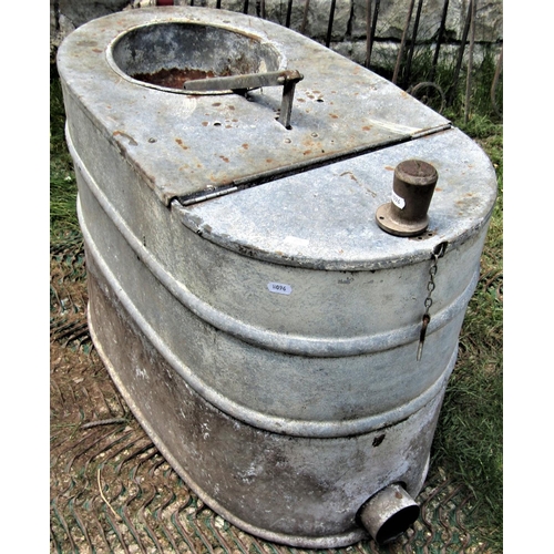 2099 - A reclaimed galvanised steel ships toilet of oval form with hinged lid and some fittings, 78 cm long... 