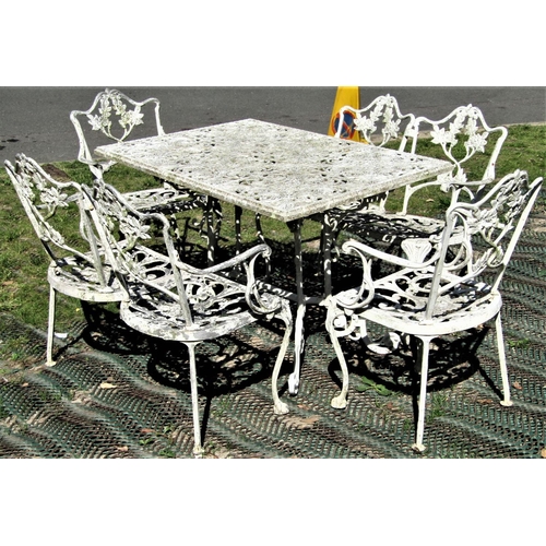 2104 - A cream painted cast aluminium garden terrace table of rectangular form with decorative pierced foli... 