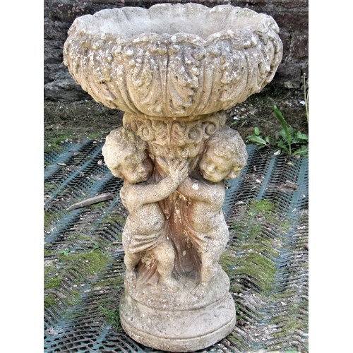 2188 - A reclaimed garden planter in the form of three cherubs supporting a circular acanthus leaf bowl, ap... 