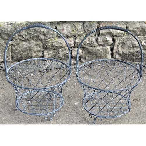 2196 - A pair of contemporary decorative galvanised wirework baskets with fixed loop handles, lattice and s... 