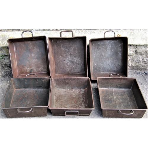 2251 - A stack of six industrial steel rectangular trays, with fixed loop handles