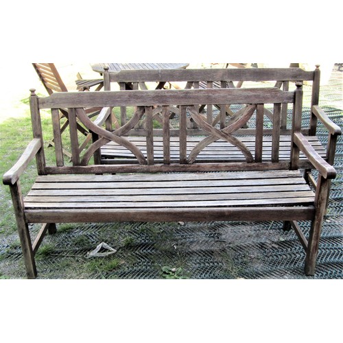 2128 - A pair of weathered contemporary hardwood three seat garden benches with slatted seats, open arms, f... 