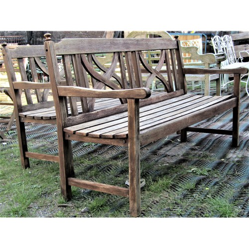 2128 - A pair of weathered contemporary hardwood three seat garden benches with slatted seats, open arms, f... 