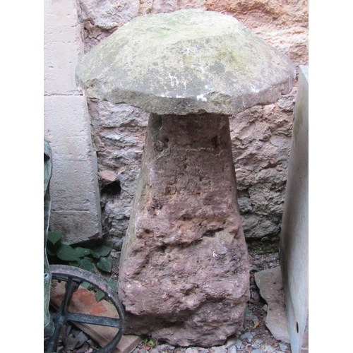 2100 - A rough hewn natural stone staddle stone of square tapered form with domed cap, 100 cm in height app... 