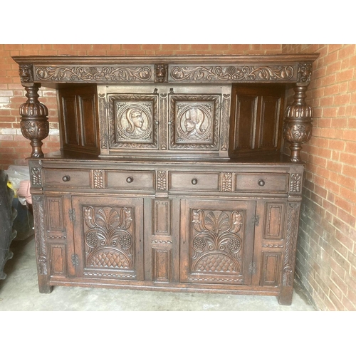 2842 - An exceptionally large oak period court cupboard, the base enclosed by a pair of panelled doors, wit... 