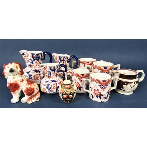 75 - A 19th century Staffordshire spaniel with red painted patches and separate forelegs, a graduated set... 