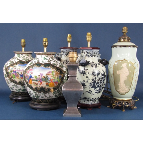 77 - A pair of lamp bases in the 18th century oriental manner with monochrome painted floral and leaf dec... 