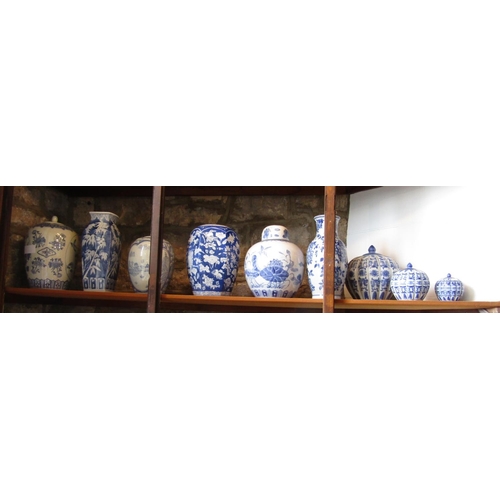 78 - A collection of reproduction oriental blue and white ceramics including three graduated vases and co... 