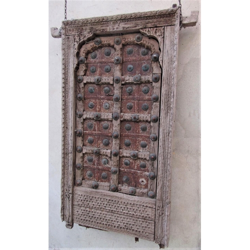 66 - An antique Indian hardwood panel with carved detail, the centre section in steel and brass overlaid,... 