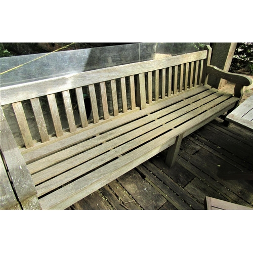 67 - A good quality weathered teak garden bench, 240cm wide