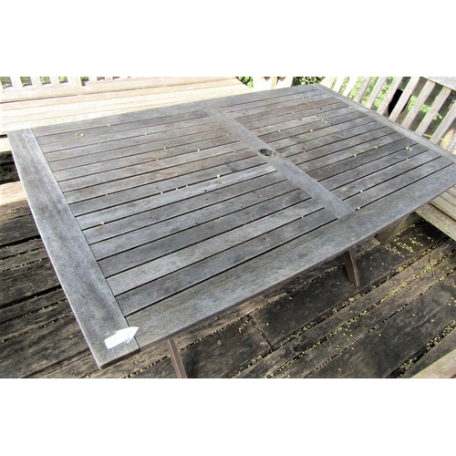 70 - A good quality weathered teak garden table with slatted top and folding x shaped frame, 155cm x 95cm... 