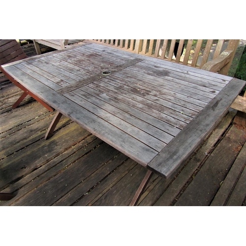 71 - A good quality weathered teak garden table with slatted top and folding x shaped frame, 155cm x 95cm... 