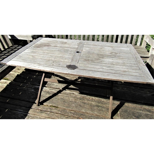 72 - A good quality weathered teak garden table with slatted top and folding x shaped frame, 155cm x 95cm... 