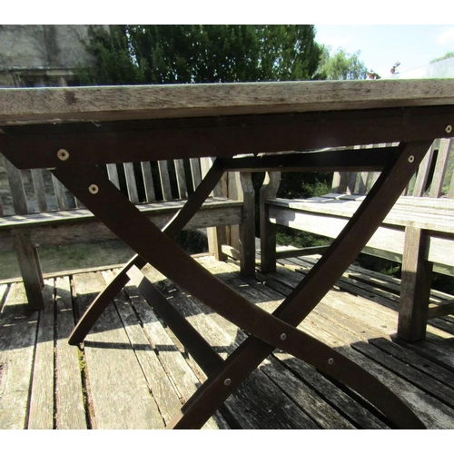 72 - A good quality weathered teak garden table with slatted top and folding x shaped frame, 155cm x 95cm... 