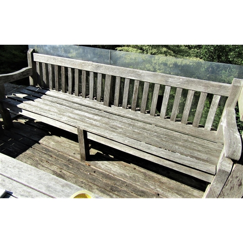 74 - A good quality weathered teak garden bench, 240cm long