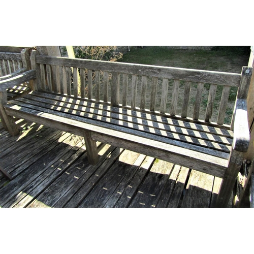 75 - A good quality weathered teak garden bench, 240cm long