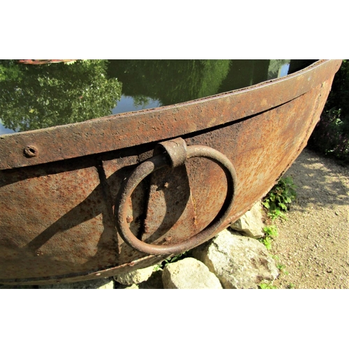 82 - A massive riveted iron cauldron with ring handles (water tight) 170cm diameter